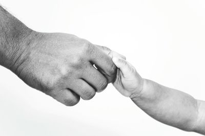 Close-up of hand holding over white background