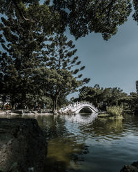 Arch bridge over river against sky