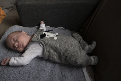 High angle view of baby sleeping on bed