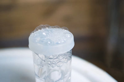 Close-up of ice cream on glass table