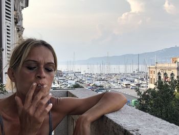 Woman smoking cigarette in balcony