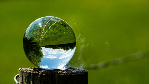 Close-up of crystal ball on glass