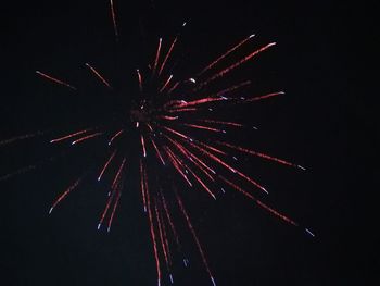 Low angle view of firework display at night