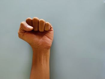 Close-up of human hand against white background
