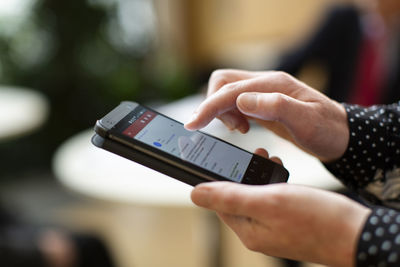 Midsection of man using mobile phone