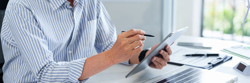 Midsection of man working in office