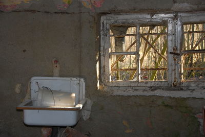 Kitchen sink on wall in abandoned house