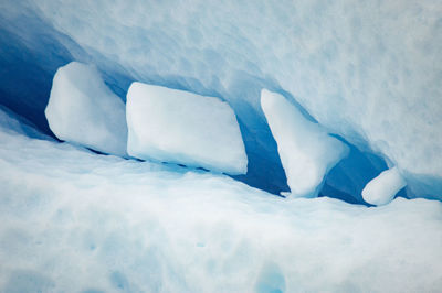 Close-up of ice cubes stuck inside iceberg.