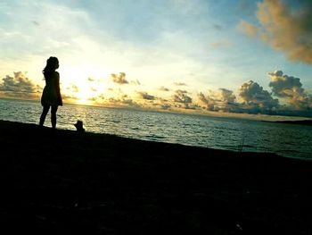 Silhouette of people looking at sunset