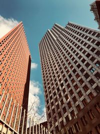 Low angle view of modern buildings against sky in city