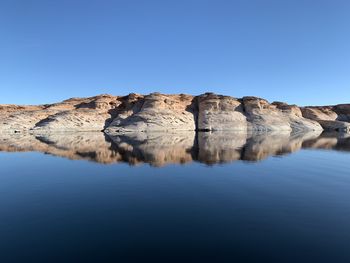 Rock formations against clear blue sky