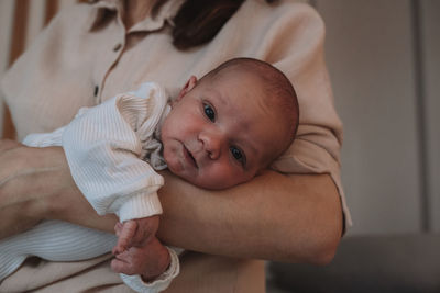 Portrait of cute baby boy lying on bed at home