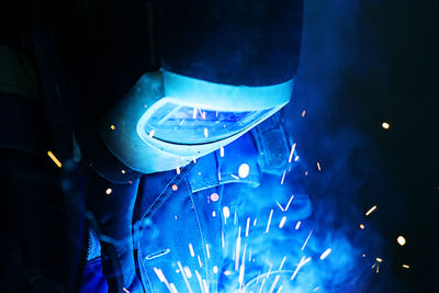 Close-up of welder wearing mask working in factory