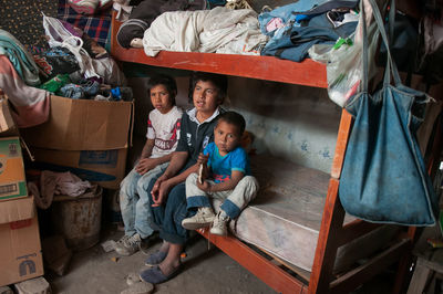Full length of children sitting on floor