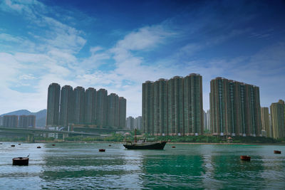 Panoramic view of sea and buildings against sky