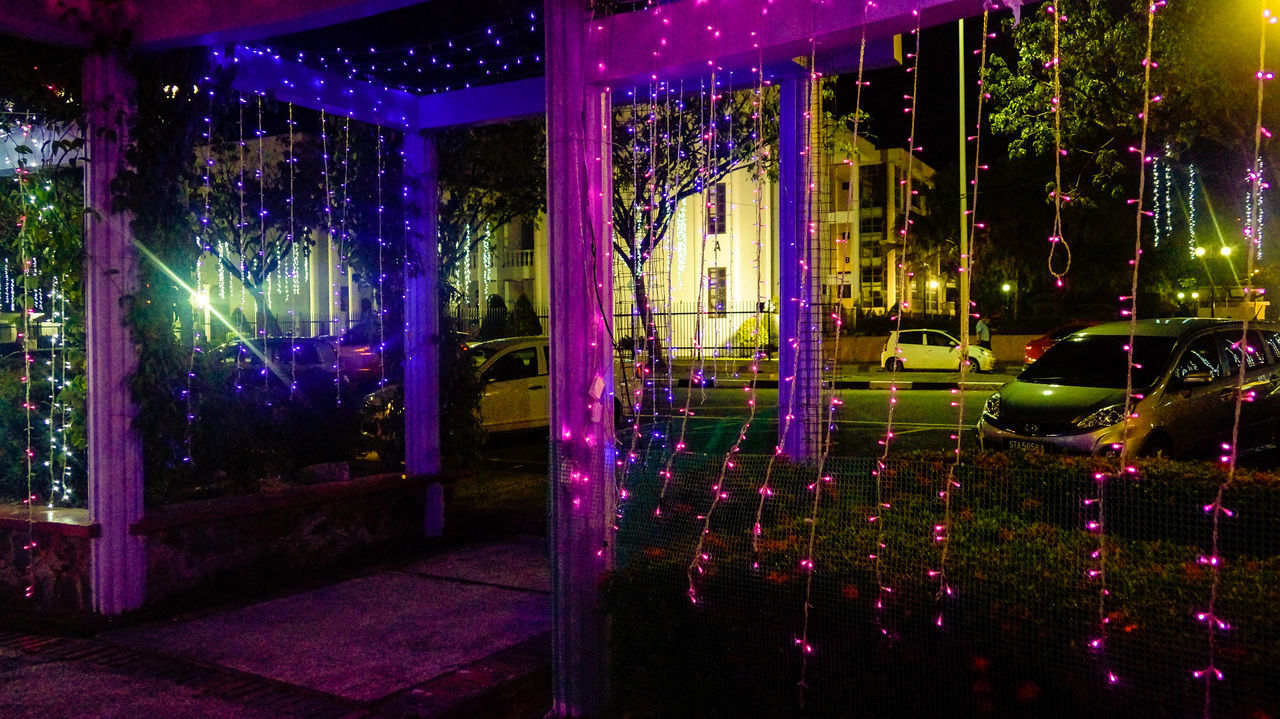 ILLUMINATED BUILDING SEEN THROUGH GLASS