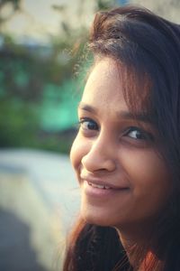 Close-up portrait of a smiling young woman