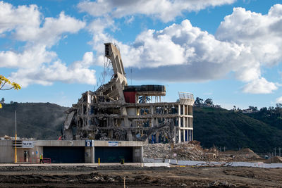 Construction site by building against sky