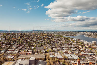 High angle view of townscape by sea against sky