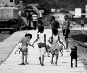 Rear view of people walking on street