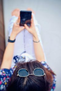 Midsection of man using mobile phone