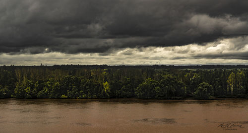 Scenic view of land against cloudy sky