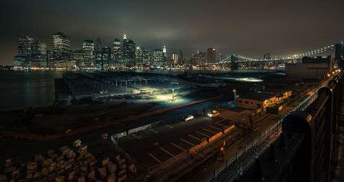 High angle view of city lit up at night