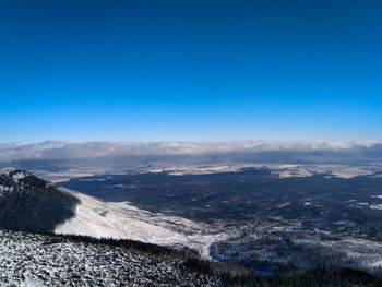 Scenic view of landscape against blue sky