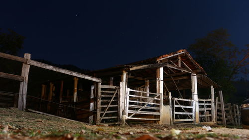 Low angle view of abandoned building against sky at night