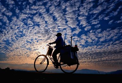 Man riding bicycle with sky morning on background