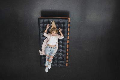 High angle view of woman lying on mattress