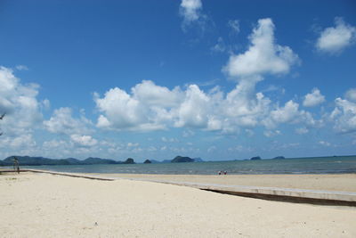 Scenic view of beach against blue sky