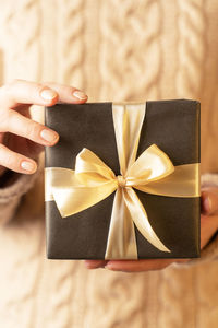 Midsection of woman holding gift