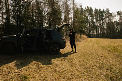 Rear view of man walking on field