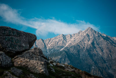 Scenic view of mountains against blue sky