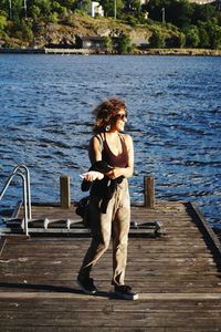 Woman sitting on pier