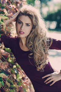 Portrait of beautiful young woman standing outdoors