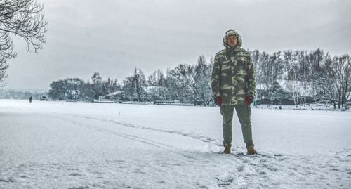 Man standing on snow covered landscape during winter