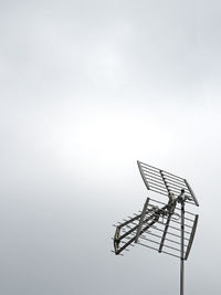 Low angle view of empty chairs against clear sky