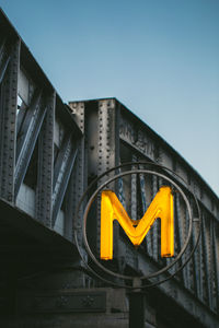 Low angle view of road sign against clear sky