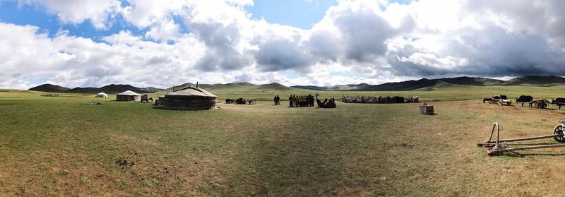 Panoramic view of agricultural field against sky