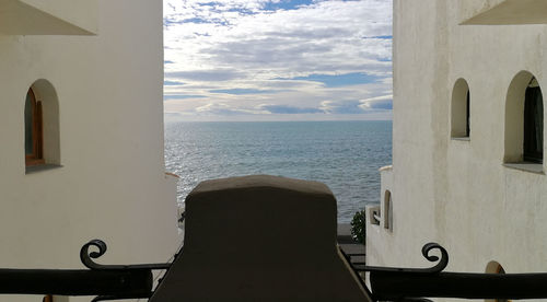Close-up of sea against sky seen through window