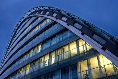 Low angle view of modern building against clear blue sky