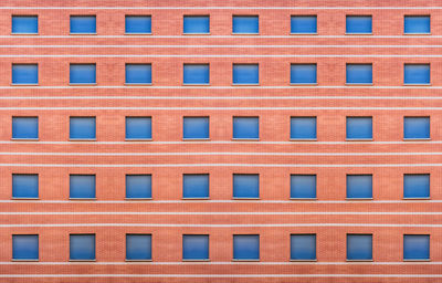 New red brick building with blue blinds