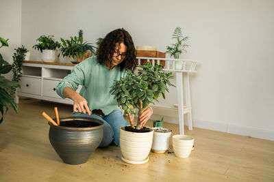 Woman holding potted plant