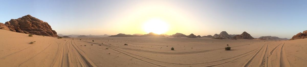 Panoramic view of desert against sky during sunset