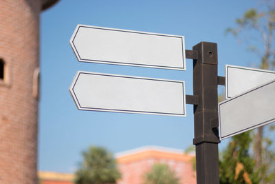 Low angle view of road sign against building