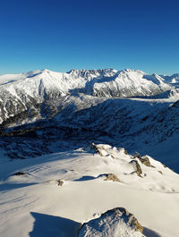 Scenic view of snowcapped mountains against clear sky
