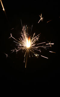 Low angle view of firework display at night