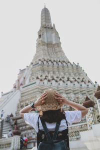 Rear view of women in temple against building